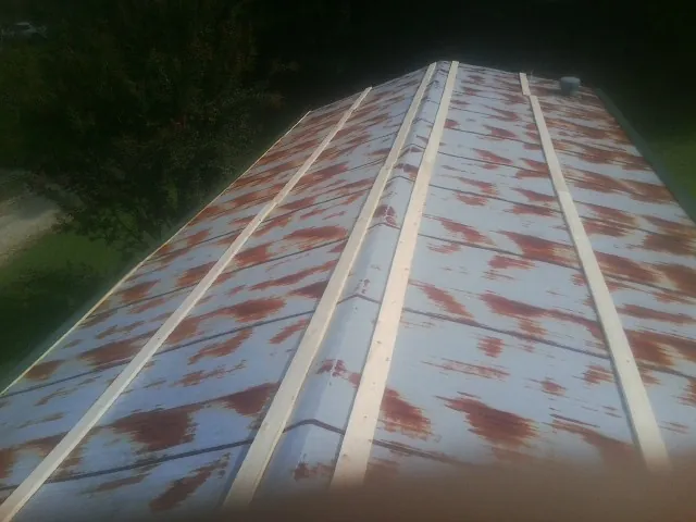 Rusted metal roof panels with new wood purlins before replacement — Storm Damage Roof Repair in Scotts Mills by Roofing Brothers